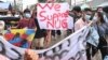 Protesters hold a banner in support of the National Unity Government (NUG) as they take part in a demonstration against the military coup in Yangon on July 7, 2021.