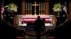 People pay their respects as the flag-draped casket of former President George H.W. Bush lies in repose at St. Martin's Episcopal Church, Dec. 5, 2018, in Houston.