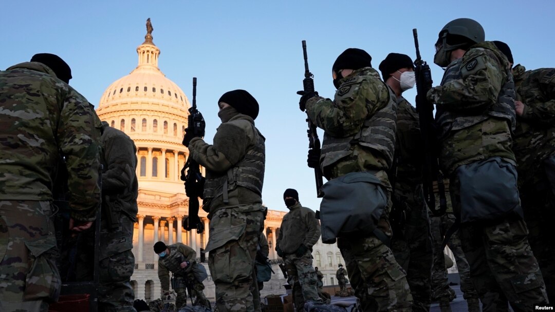 Miembros de la Guardia Nacional reciben armas antes de que los demócratas comiencen a debatir un artículo de juicio político contra el presidente de Estados Unidos, Donald Trump, en el Capitolio de Estados Unidos, en Washington, el 13 de enero de 2021. 