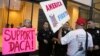 FILE - A supporter of President Donald Trump challenges police officers and a Deferred Action for Childhood Arrivals (DACA) program advocate during a rally outside the office of California Democratic Sen. Dianne Feinstein in Los Angeles, California, Jan. 