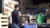 A worker unloads produce at a Paris market that has since been shuttered because of coronavirus-related health restrictions. (VOA/Lisa Bryant)