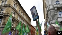 FILE - People march during a protest against the government's alleged use of powerful spyware to spy on opponents, in Budapest, Hungary, July 26, 2021.