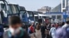 Travelers wait to board buses as they prepare to leave Istanbul from the city's Esenler national bus station, April 29, 2021, ahead of a new national COVID lockdown.