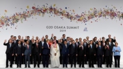 President Donald Trump talks with Saudi Arabia's Crown Prince Mohammed bin Salman during a group photo at the G-20 summit in Osaka, Japan, June 28, 2019.