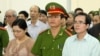 A U.S-trained lawyer and well-known dissident Le Quoc Quan (r) listens to the judge during his trial in Hanoi, Vietnam, Oct. 2, 2013. 