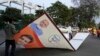 Municipal workers remove a hoarding displaying an image of Indian Prime Minister Narendra Modi in Lucknow, in the central Indian state of Uttar Pradesh, on March 16, 2024. India's six-week-long general elections will start on April 19,