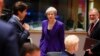 British Prime Minister Theresa May, center, arrives for a round table meeting at an EU summit in Brussels, Oct. 18, 2018.