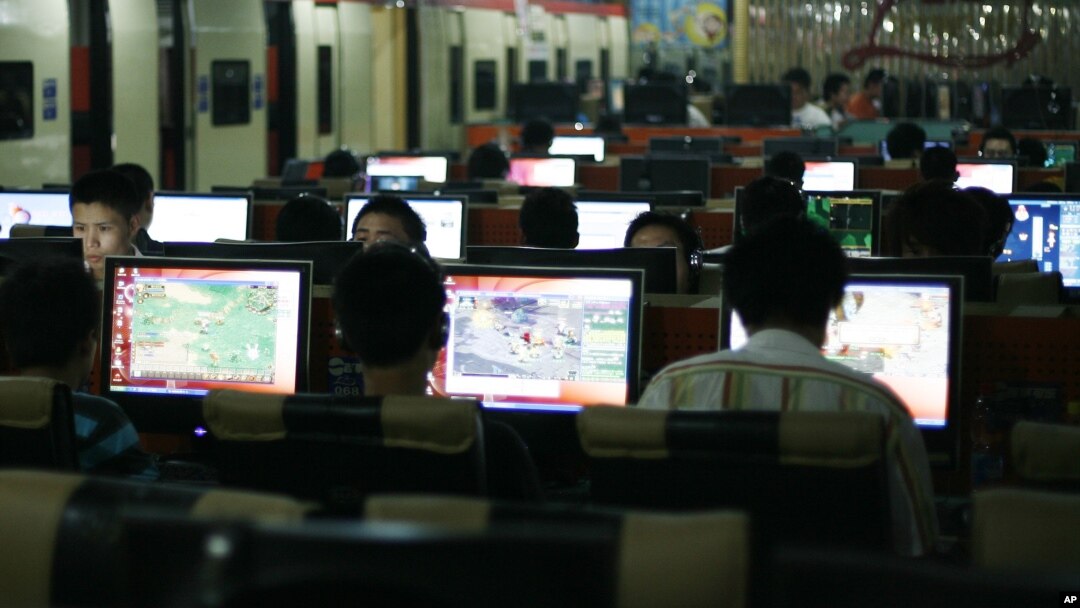 FILE - Customers surf the Internet at an Internet cafe in Beijing, China.