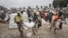 Men carry a sack of wheat during a food distribution by the World Food Programme (WFP) for internally displaced people (IDP) in Debark, 90 kilometers of the city of Gondar, Ethiopia, Sept. 15, 2021.