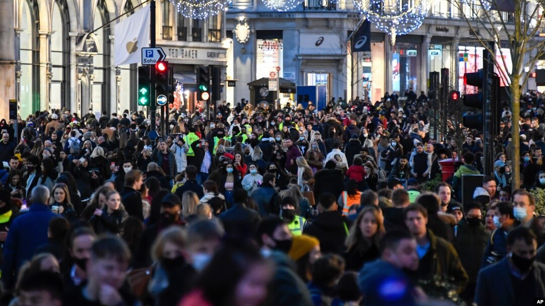 Crowds of shoppers walk under the Christmas lights in Regent Street, in London, Saturday, Dec. 12, 2020. Health Secretary Matt Hancock says infections are starting to rise in some areas after falling during a four-week national lockdown in England…