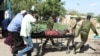 A man is transported on a stretcher after he was injured when a bus he was riding in drove onto a roadside bomb, near the Kenya-Somalia border in Mandera county, Kenya, Jan. 31, 2022. 