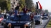 Syrian government supporters wave national flags and chant slogans against U.S. President Trump during demonstrations following a wave of U.S., British and French military strikes to punish President Bashar Assad for suspected chemical attack against civi