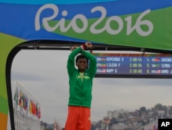 FILE - Ethiopian silver medalist Feyisa Lilesa crosses his arms on the podium after the men’s marathon at the 2016 Summer Olympics in Rio de Janeiro, Brazil, Aug. 21, 2016.