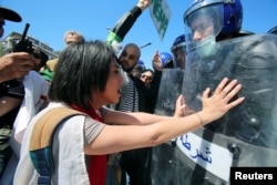 Police officers and demonstrators are at a standoff during a May Day protest in Algiers, Algeria, May 1, 2019.