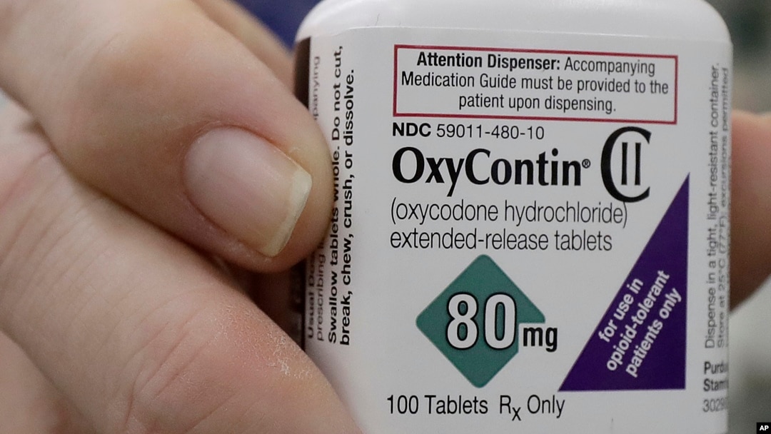 FILE - Pharmacist Steve Protzel holds a bottle of OxyContin in San Francisco, April 2, 2018. 