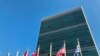 FILE - Flags fly outside the United Nations headquarters during the 74th session of the United Nations General Assembly, Sept. 28, 2019.