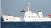 A combination photo shows two Chinese surveillance ships which sailed between a Philippines warship and eight Chinese fishing boats to prevent the arrest of any fishermen in the Scarborough Shoal, April 10, 2012.