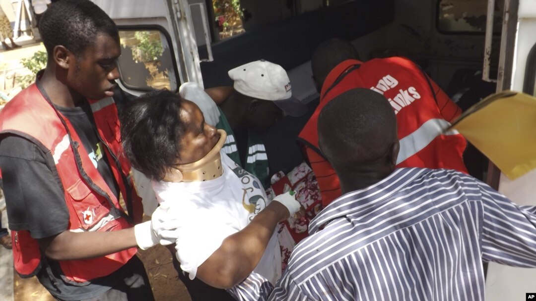 A woman injured in a grenade attack at the Utawala Inter-denominational church is helped into ambulance in Garissa, northern Kenya, November 4, 2012. 