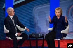 Democratic presidential candidate Hillary Clinton, right, speaks alongside host Anderson Cooper during a Democratic primary town hall sponsored by CNN, in Derry, N.H., Feb. 3, 2016.