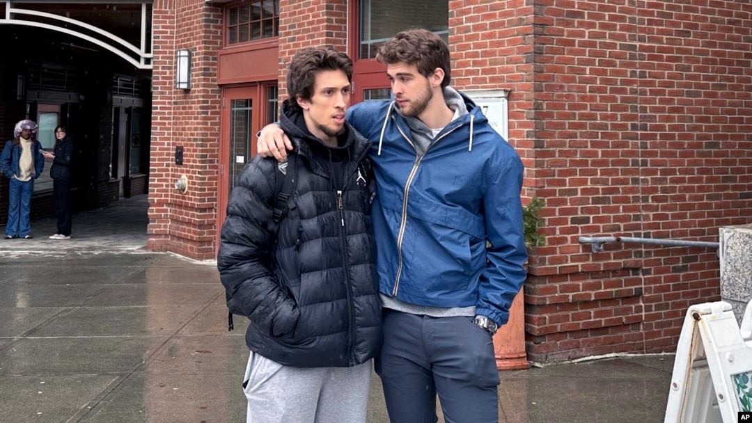 Basketball players Romeo Myrthil, left, and Cade Haskins talk after voting at Dartmouth College in Hanover, New Hampshire, on March 5, 2024, on whether to form a union.