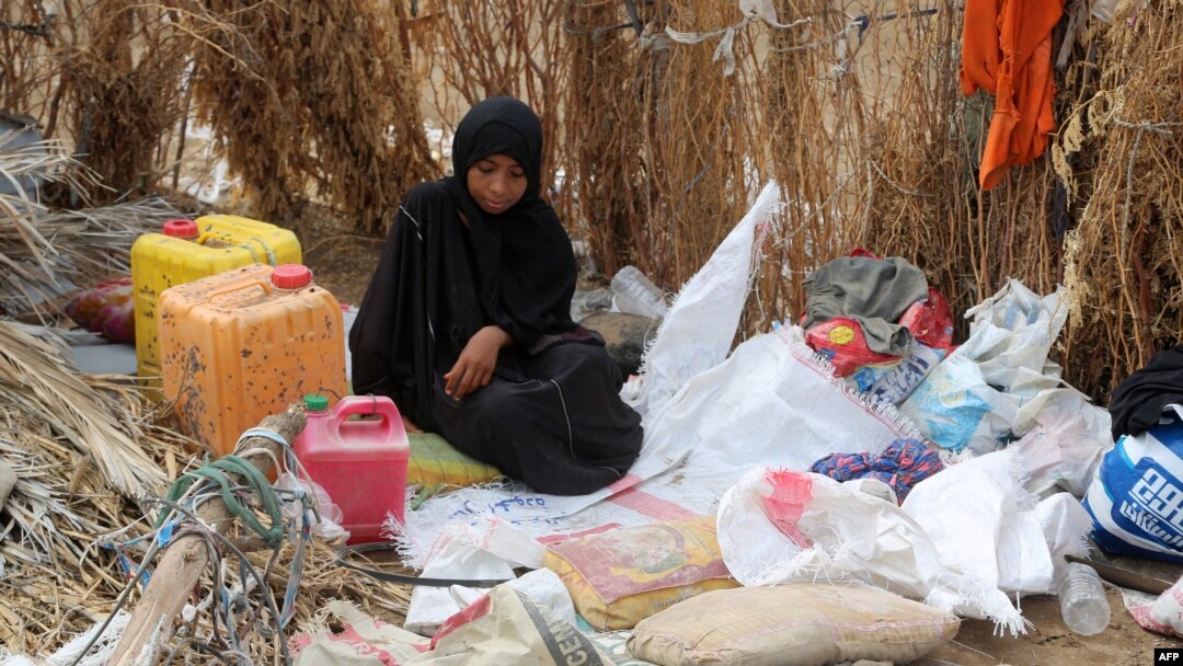 FILE - A Yemeni woman sits in the remains of a home in a neighborhood ravaged by Tropical Cyclone Sagar, in the port city of Hodeidah, Yemen, May 19, 2018. Tropical Cyclone Luban devastated the southeastern coast of Yemen earlier this week.