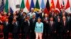 U.S. President Barack Obama, front row third from left, Chinese President Xi Jinping, second from right, and other leaders wave as they pose for a group photo session for the G-20 Summit held at the Hangzhou International Expo Center.