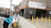 Emergency Medical Technicians move a patient while wearing personal protective equipment outside of Elmhurst Hospital during the ongoing outbreak of the coronavirus disease (COVID-19) in the Queens borough of New York, April 20, 2020.