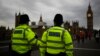 FILE - Police officers patrol Westminster Bridge with the Houses of Parliament in the background, in London, Britain, June 8, 2017.