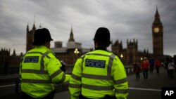 FILE - Police officers patrol Westminster Bridge with the Houses of Parliament in the background, in London, Britain, June 8, 2017.