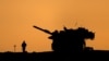 The silhouettes of a military vehicle and a soldier are seen near the Gaza border, amid the ongoing conflict in Gaza between Israel and Hamas, in Israel, Dec. 16, 2024. 