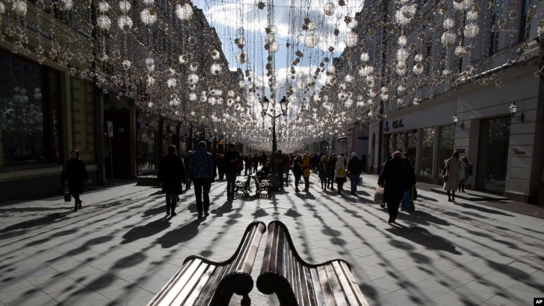 FILE - People walk along Nikolskaya Street near the Kremlin on a sunny day in Moscow, Russia, March 9, 2019. 