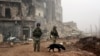 FILE - This photo made from the footage taken from Russian Defense Ministry official website on Feb. 4, 2017, claims to show Russian soldiers in a street in Aleppo, Syria. 