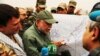 FILE - Hadi al-Amiri, leader of the Badr Brigades Shiite militia, explains a battle plan to his fighters on the outskirts of Fallujah, Iraq, June 1, 2015. A base hit by a drone attack, July 19, 2019, reportedly belonged to the Badr Brigades.