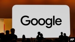 FILE - Audience members gather at Made by Google for new product announcements at Google on Aug. 13, 2024, in Mountain View, Calif. 