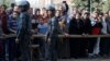 People gather at the site of attack on a church in the Helwan district south of Cairo, Egypt, Dec. 29, 2017.