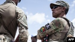 FILE - Members of the Close Protection Unit for Central African Republic President Faustin-Archange Touadéra, composed of Russian private security company operatives from Sewa Security, are seen in Berengo.