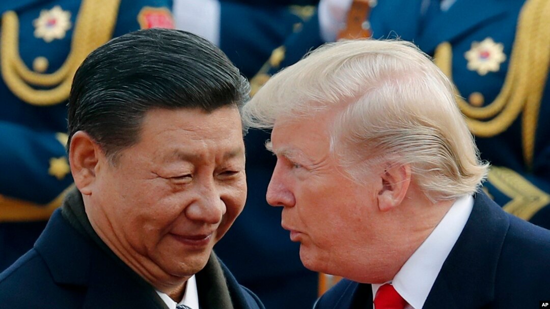 FILE - US President Donald Trump chats with Chinese President Xi Jinping during a welcome ceremony at the Great Hall of the People in Beijing on Nov. 9, 2017.