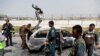 Afghan police officers inspect a vehicle from which insurgents fired rockets, in Kabul, Afghanistan, Aug. 18, 2020.