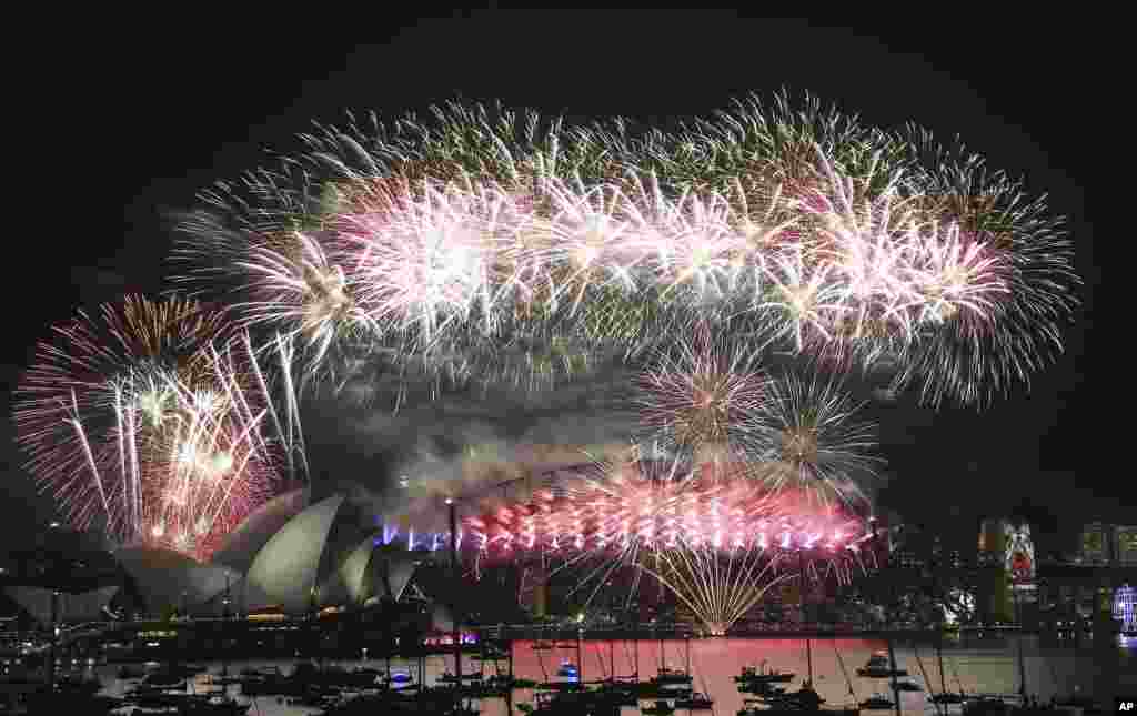 Fireworks explode over the Opera House and Harbour Bridge during a New Year's Eve fireworks display in Sydney, Australia, Jan. 1, 2016.