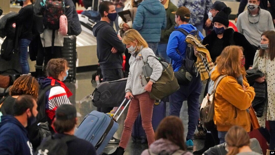 Travelers pass through Salt Lake City International Airport, Jan. 5, 2022, in Salt Lake City. 