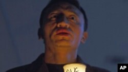An exiled Tibetan participates in a candlelit vigil to show solidarity with self-immolators in Tibet in Dharmsala, India, Nov. 28, 2012.