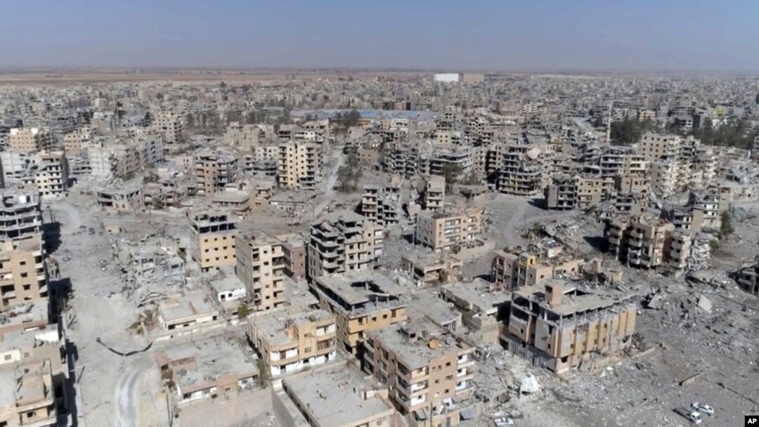 This Thursday, Oct. 19, 2017 frame grab made from drone video shows damaged buildings in Raqqa, Syria two days after Syrian Democratic Forces said that military operations to oust the Islamic State group have ended and that their fighters have taken full control of the city.