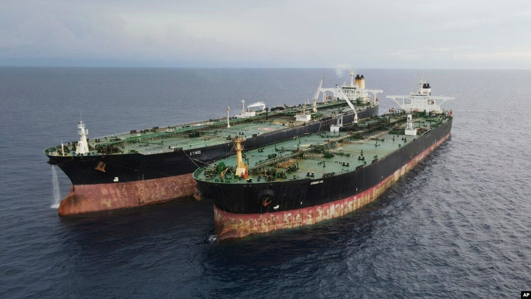 In this undated photo released July 11, 2023, by the Indonesian Maritime Security Agency, Iranian-flagged tanker MT Arman 114, right, and Cameroon-flagged tanker, MT S Tinos, are seen after they are caught conducting illegal oil transfers.