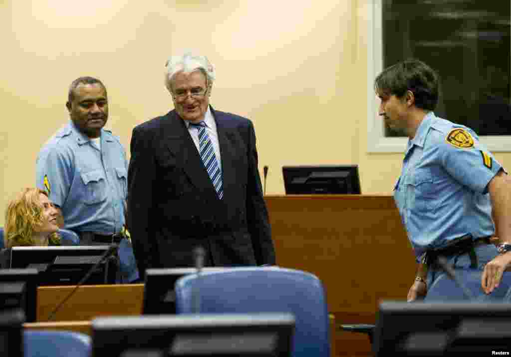 Radovan Karadzic enters the courtroom on the first day of his defense against war crime charges at the International Criminal Tribunal for the Former Yugoslavia in The Hague October 16, 2012.