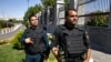 FILE - Police patrol outside Iran's parliament building, in Tehran, Iran, June 7, 2017.