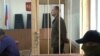 FILE - Eston Kohver of Estonia stands behind bars in Pskov, Russia, Sept. 17, 2014.