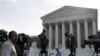 Members of the media gather for a stakeout in front of U.S. Supreme Court in Washington, June 25, 2012