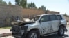 Afghan security forces inspect the site of a car bomb attack that targeted Laghman provincial governors convoy, in Mihtarlam, Laghman Province, Oct. 5, 2020.