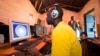 FILE - Young men surf the internet at a cyber cafe on June 20, 2012, in Nairobi, Kenya.