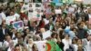 Algerians, many of them medical professionals and students, march with banners and flags during an anti-government protest in Algiers, Algeria, March 19, 2019.